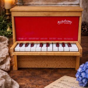 Vintage Michelsonne toy piano from the 1960s in wood with red front panel