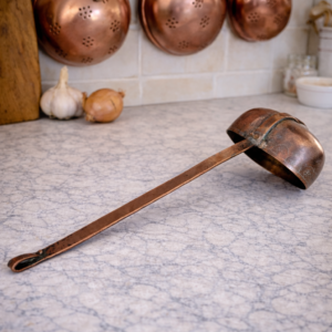 Antique copper ladle with long handle and engraved bowl, handcrafted rustic French kitchen tool