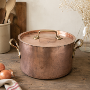 Antique Dehillerin copper stockpot with bronze handles and heavy French cookware craftsmanship