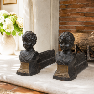 Antique French cast iron andirons with child bust sculptures in Napoleon III style