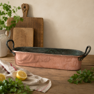 Antique French copper fish poacher with bronze handles and aged copper patina used as decorative French country piece