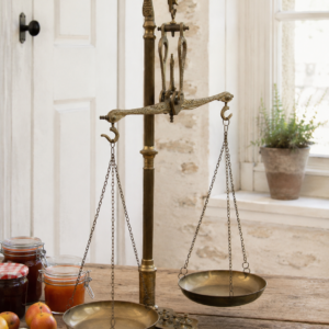 Large antique French brass balance scale with hanging trays, decorative bird motifs, and original weights