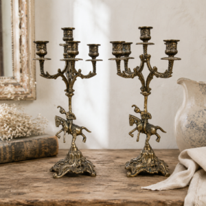 Pair of vintage brass knight candelabras with five candle arms and ornate French decorative details