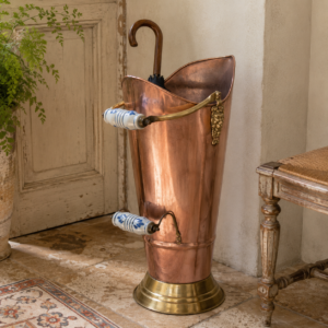 Vintage copper umbrella stand with lion head handles and ceramic grips in a two-tone French design