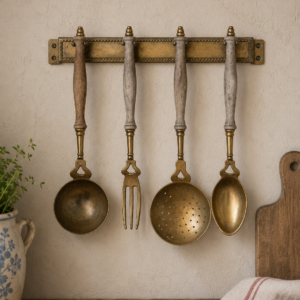 Vintage French brass and wood kitchen utensil set with wall rack displayed as French country kitchen décor