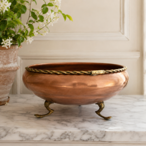 Vintage copper planter bowl with claw feet and decorative brass trim in French country style