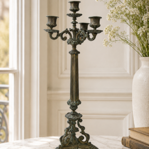 Vintage French gold metal candelabra with ornate scroll arms and aged patina decorative candle holder