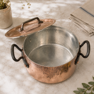 Vintage hammered copper stew pot with lid and cast iron handles in thick French tinned copper cookware style